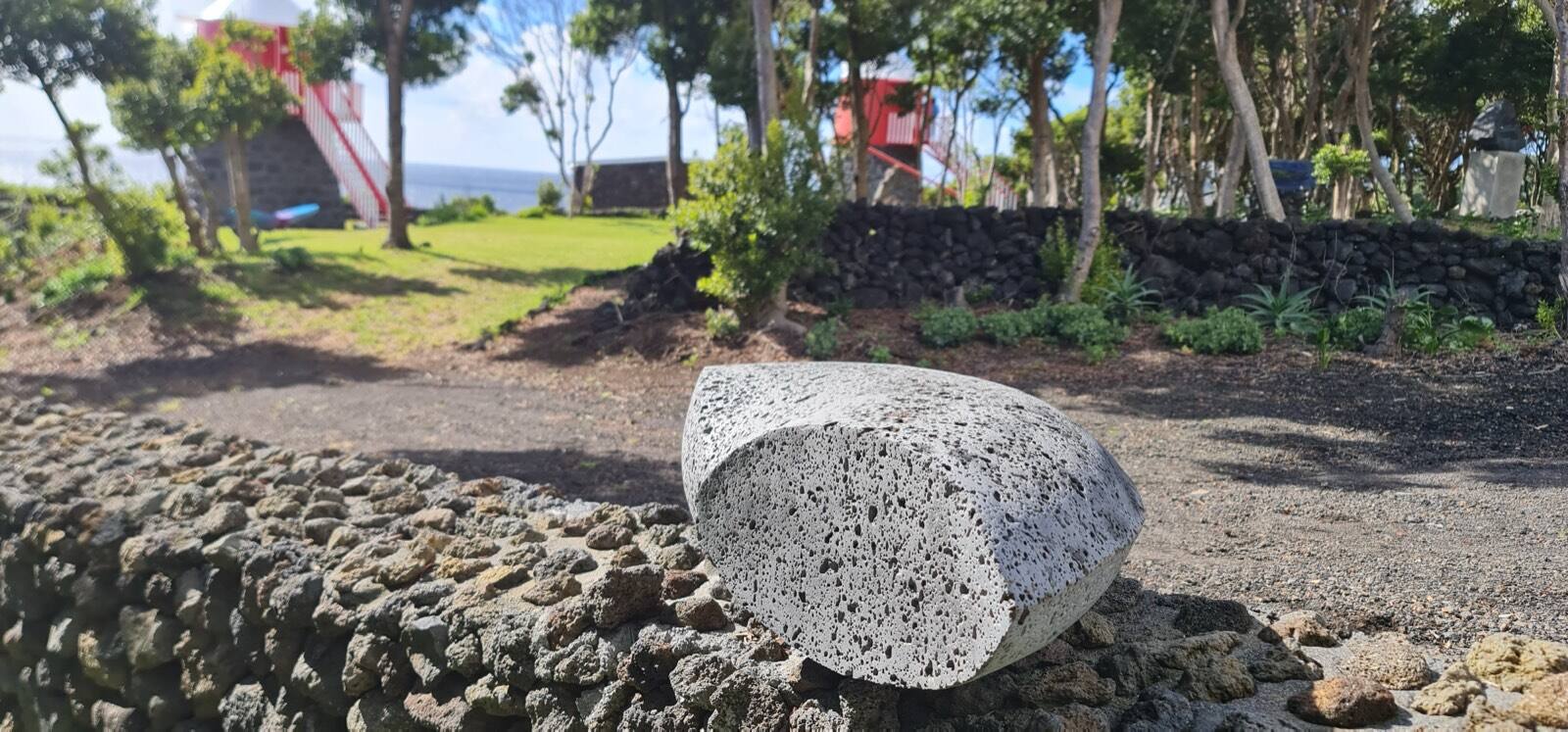 The NU´VEM property inside a protected nature reserve, with lava-stone walls and greenery